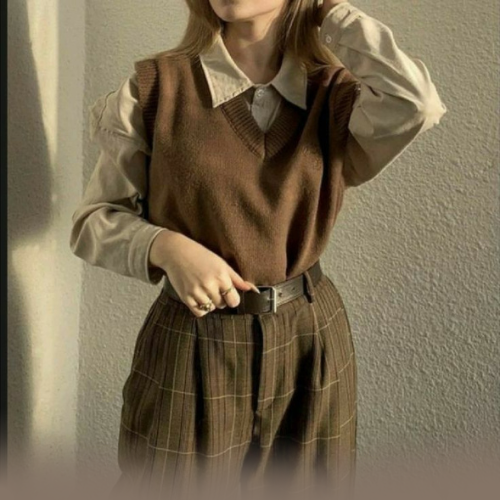 woman wearing brown sweater with ligh shirt and belt