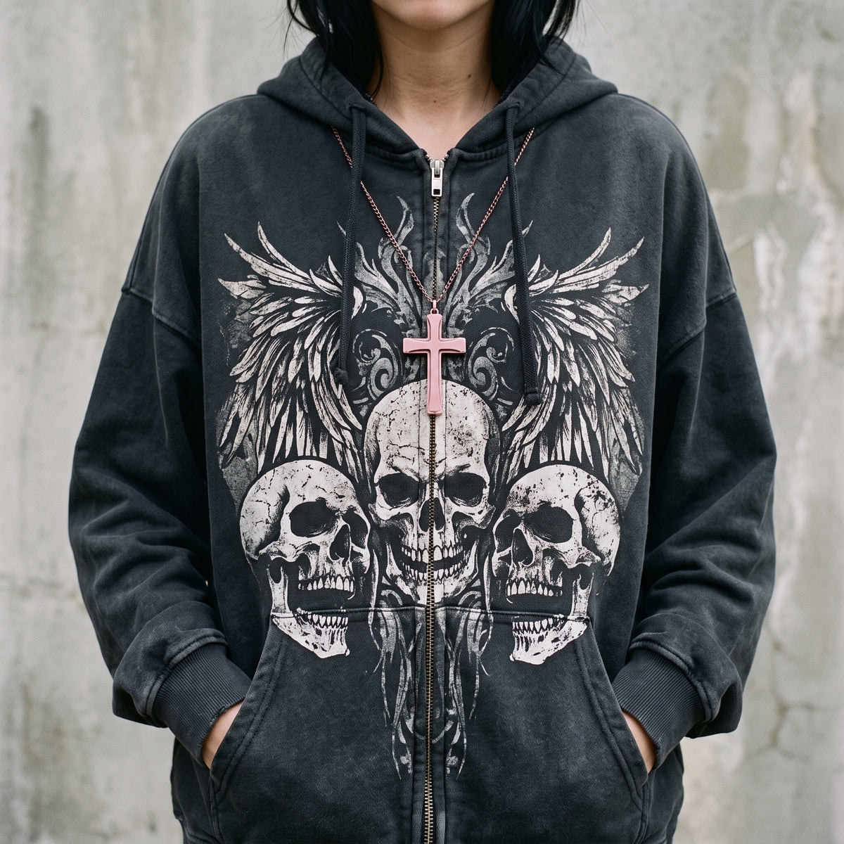 Close-up of the skull and wings print on the black zip up hoodie