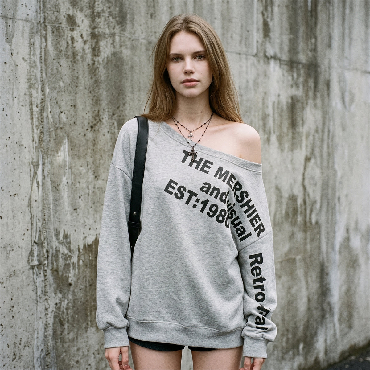 Woman wearing the grey Mershier oversized sweatshirt off one shoulder